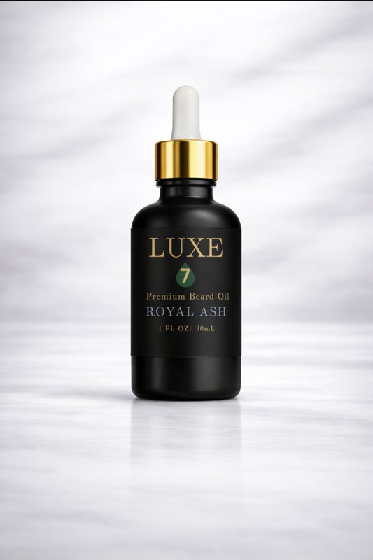 Luxe 7 Royal Ash Premium Beard Oil in a 1 fl oz (30 mL) black glass bottle with a gold-and-white dropper on a light marble background.